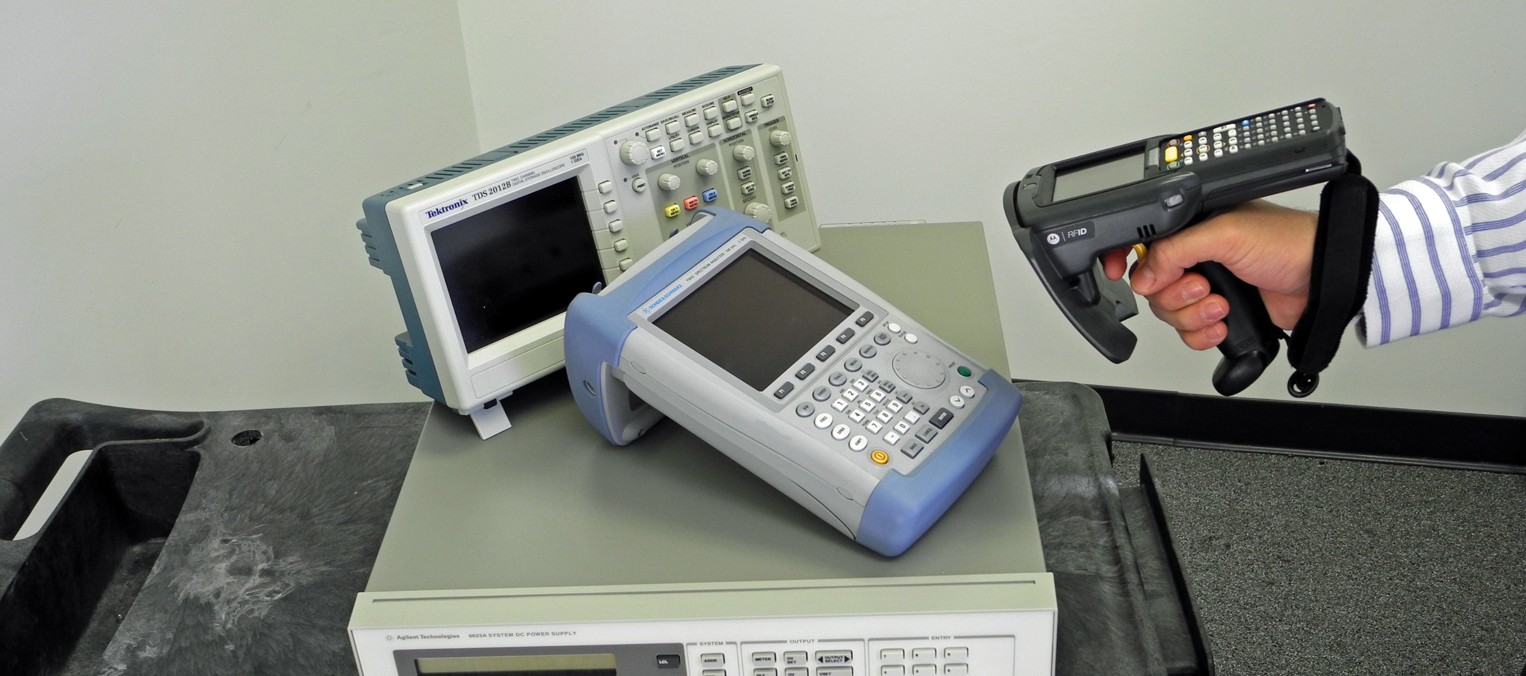 Handheld RFID reader scanning calibrated test and inspection equipment
